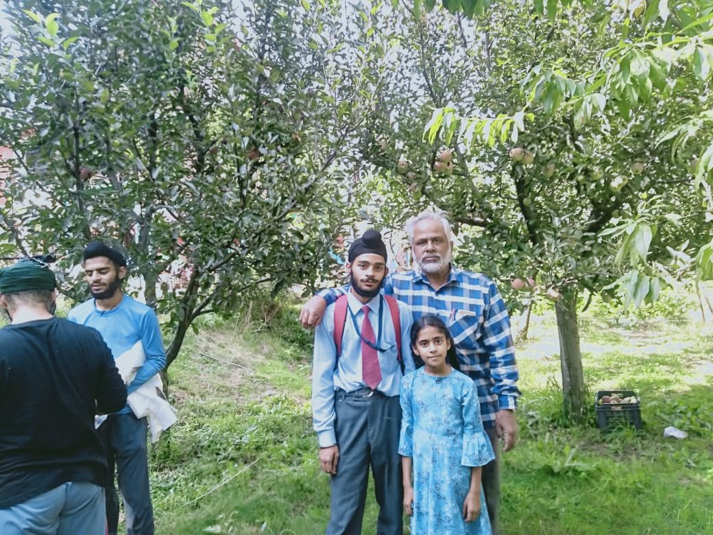Our Secretary in an apple garden in Kashmir